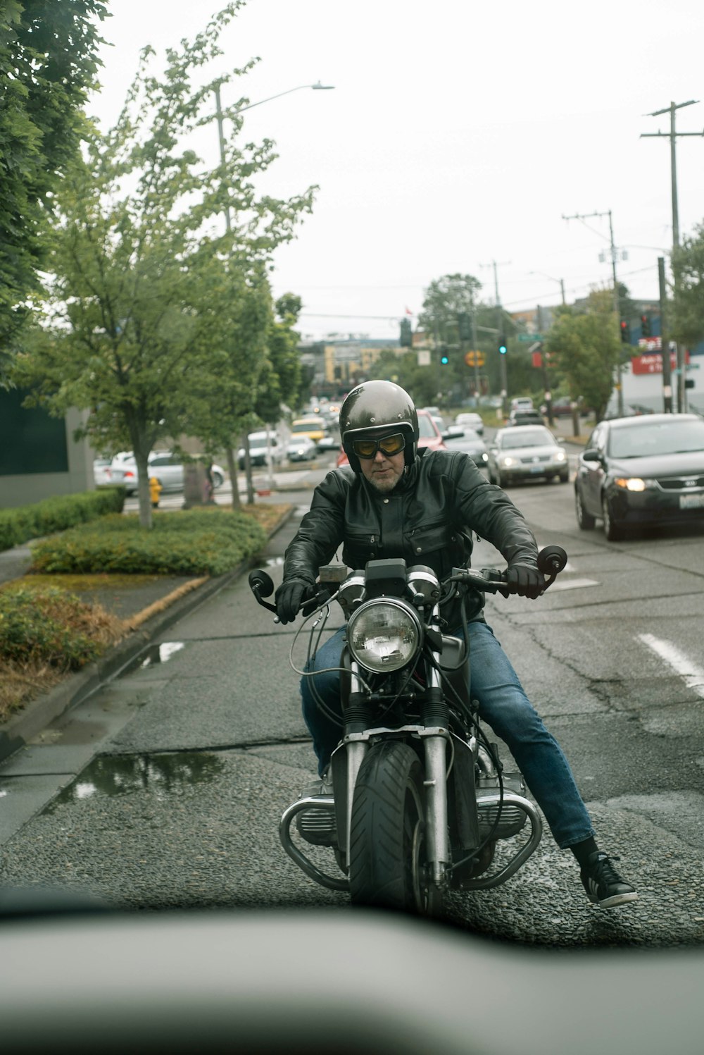 man in black helmet riding motorcycle on road during daytime