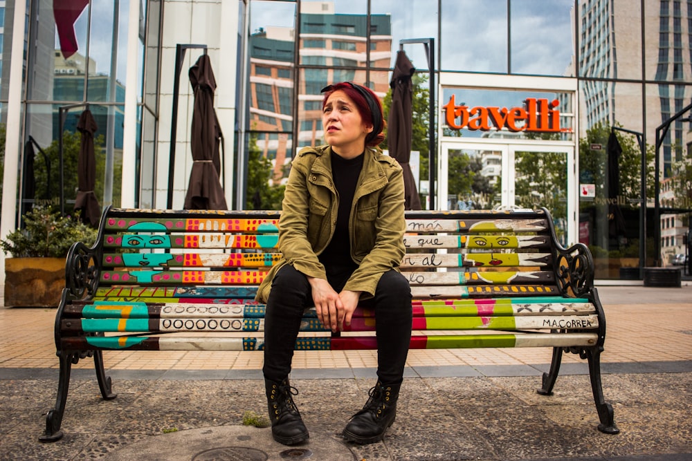 woman in brown coat sitting on bench