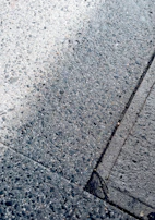 Before and after comparison of an asphalt surface, illustrating the transformation after sealing.
