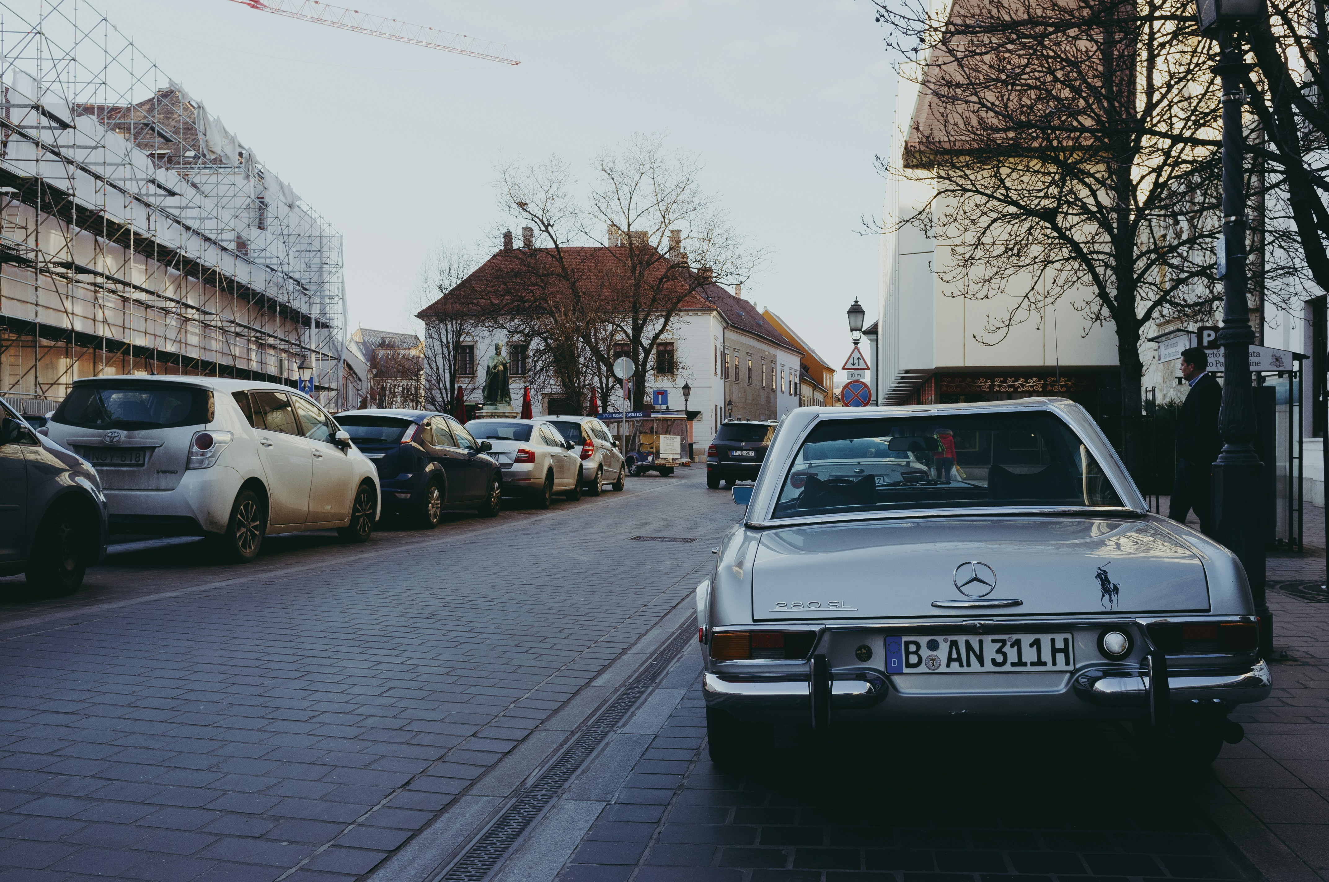 cars parked on sidewalk during daytime