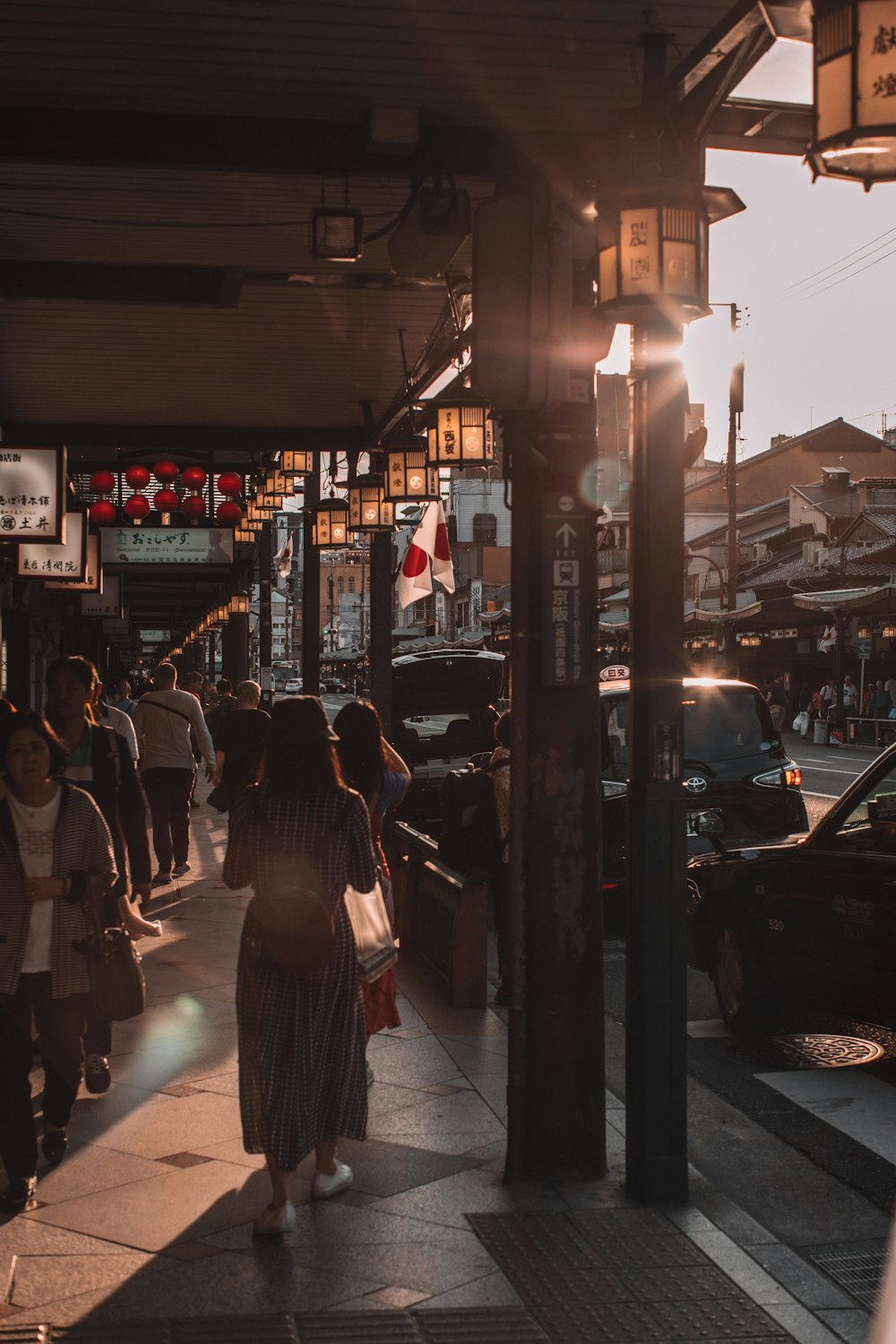 people walking on sidewalk during night time