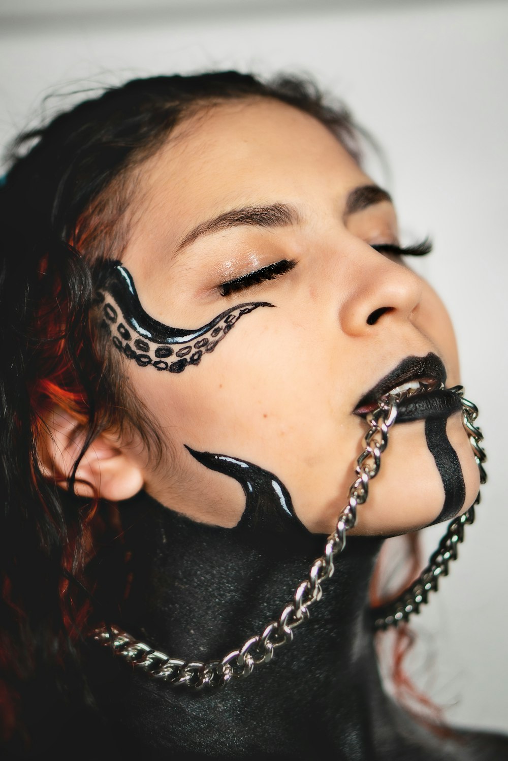 woman with silver and black earrings