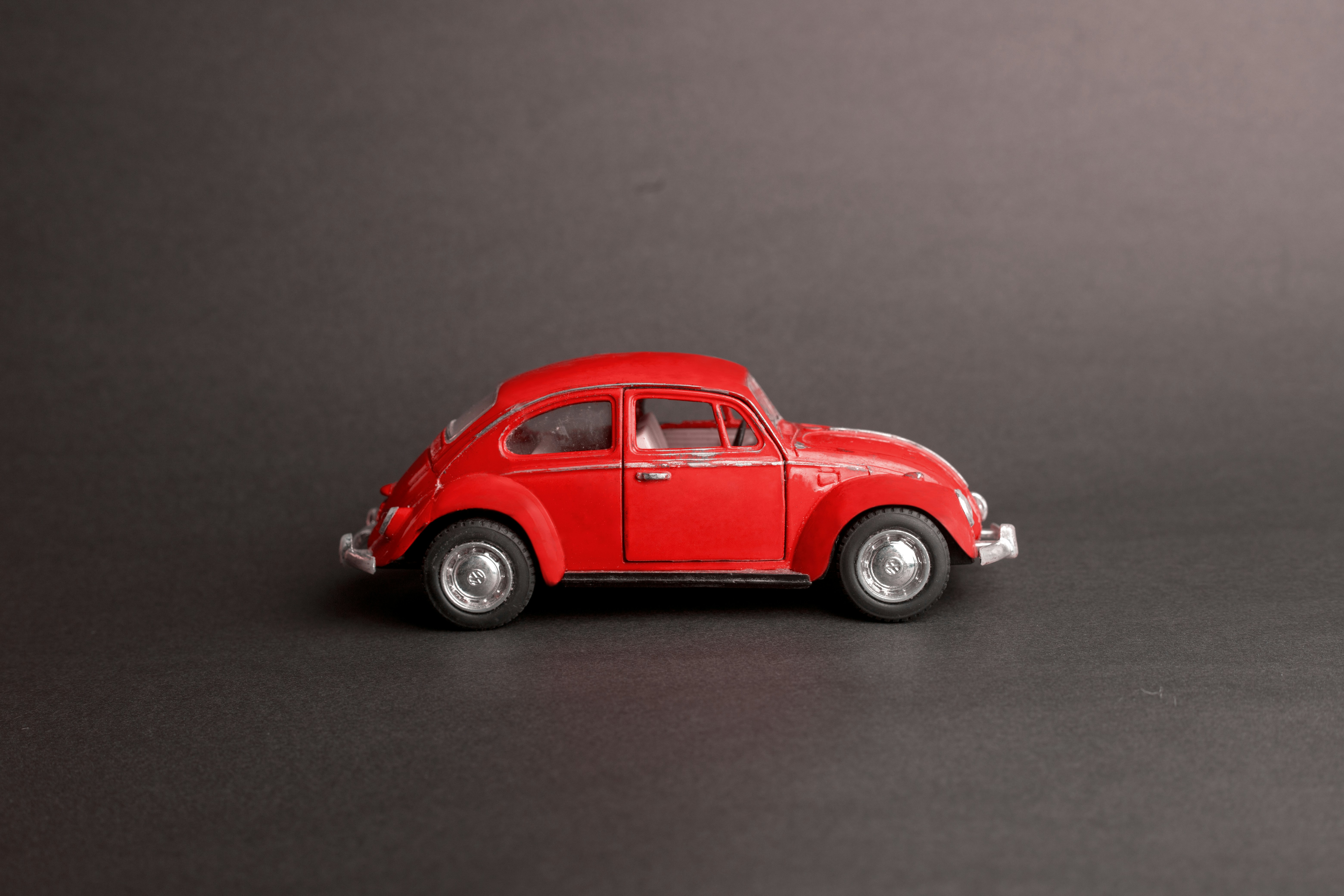 Side profile of a restored Volkswagen Beetle showcasing clean lines and vibrant paint