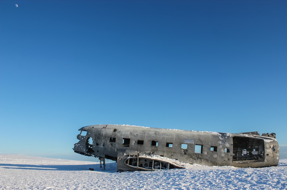 wrecked ship on white sand during daytime