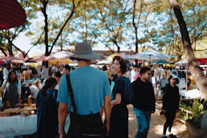 A joyful family exploring a vibrant local market during a sunny day trip