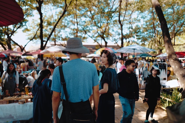 A joyful family exploring a vibrant local market during a sunny day tour.