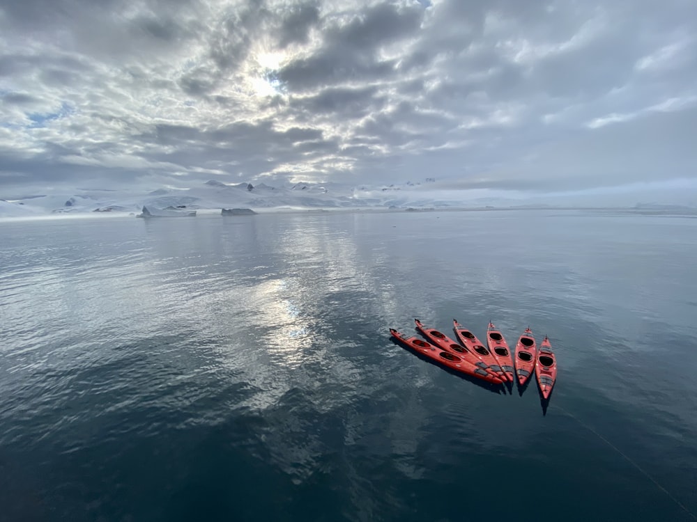 red kayak on blue sea under blue sky during daytime