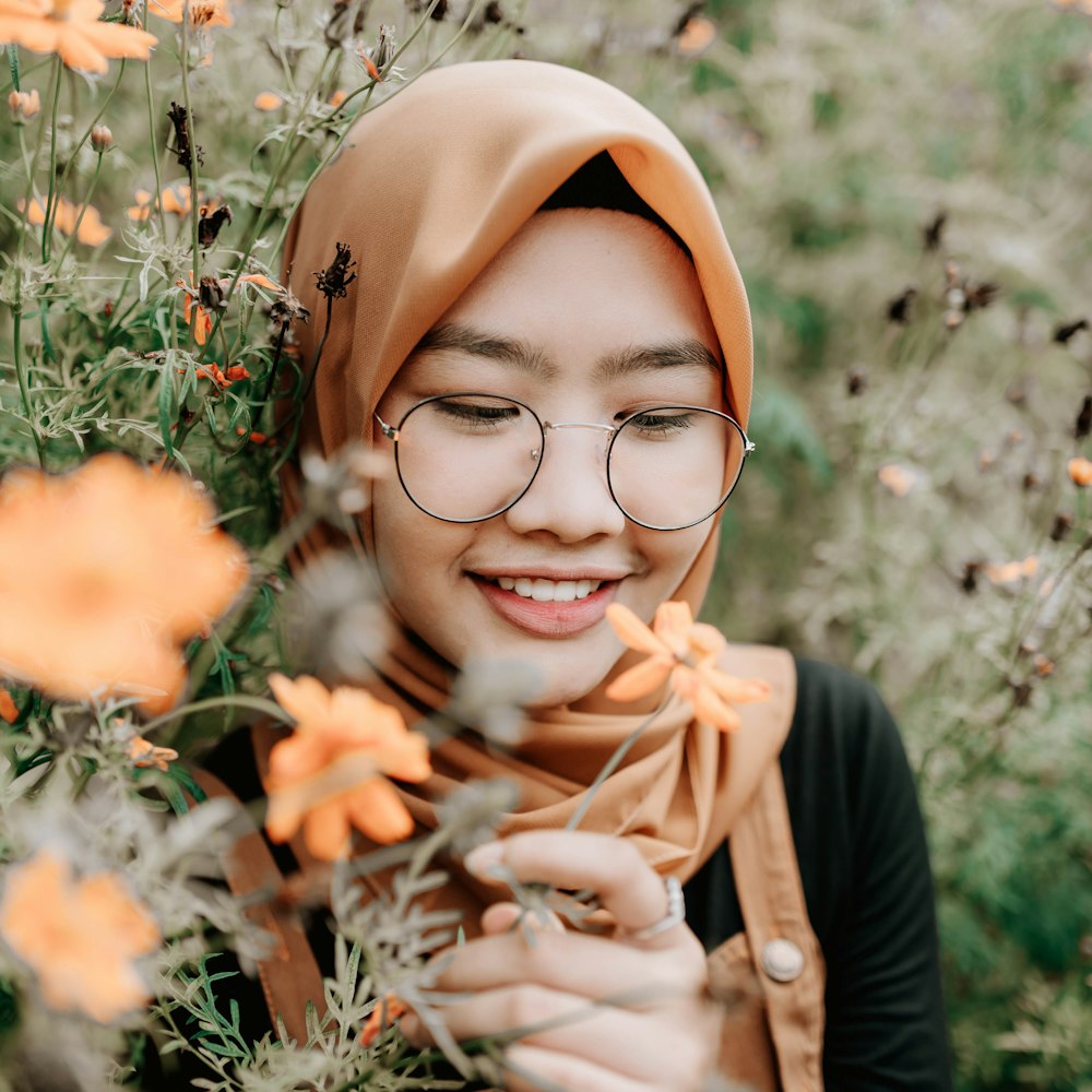 woman in brown hijab and brown long sleeve shirt smiling