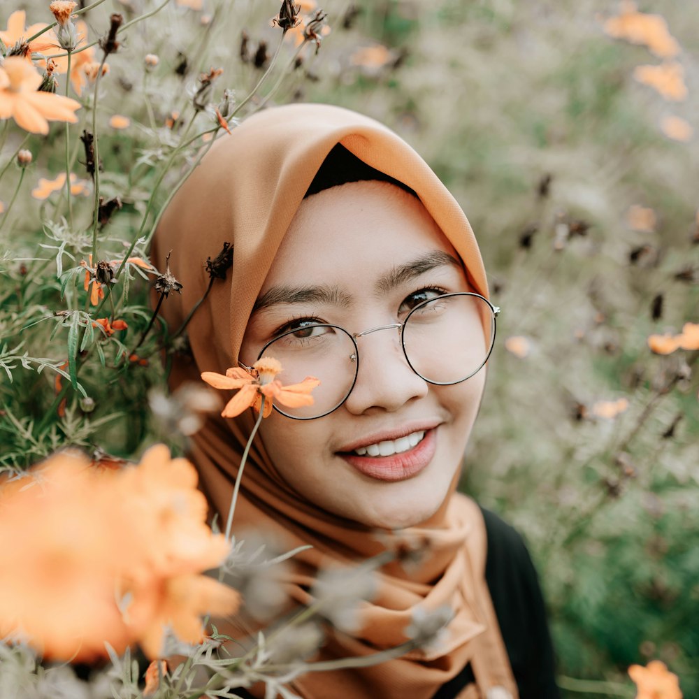 woman in brown hijab and eyeglasses
