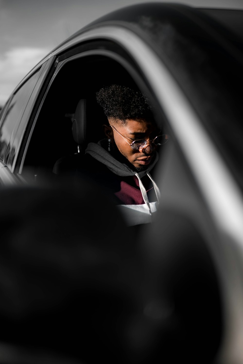 man in black suit jacket driving car