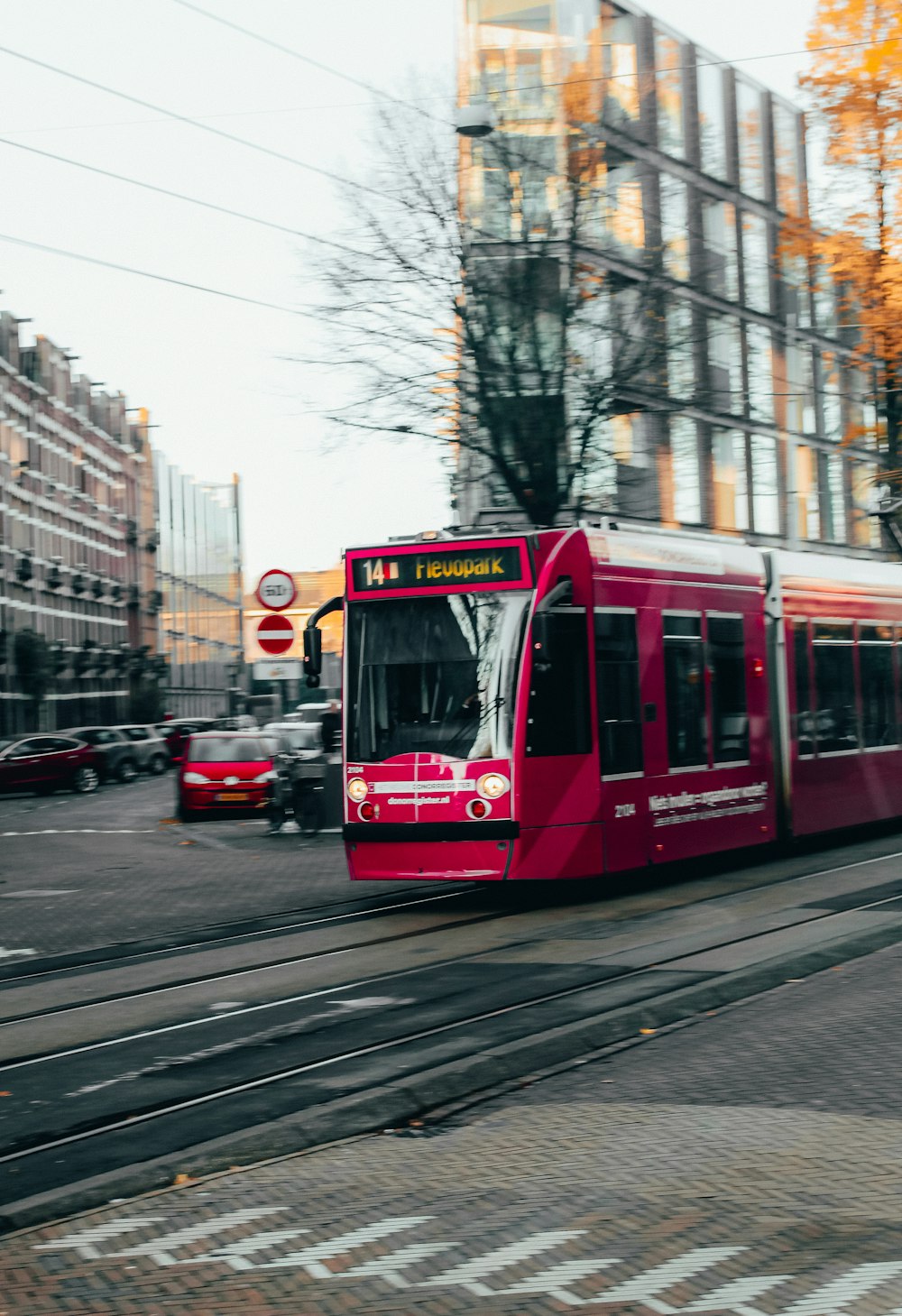 red and white tram on road during daytime