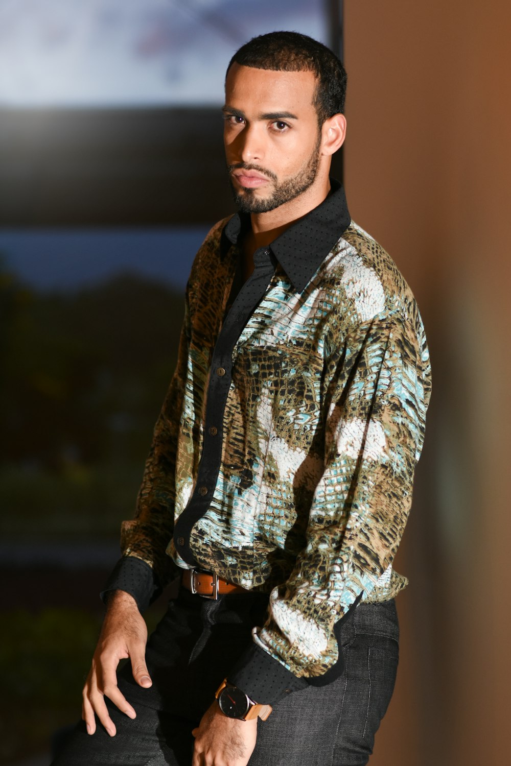 man in blue and white floral button up shirt standing during daytime