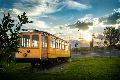 yellow train on rail road under cloudy sky during daytime montana zoom background