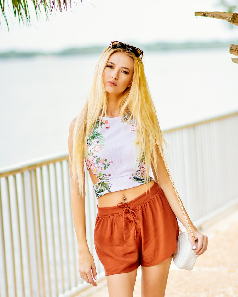 woman in white and red floral crop top and red shorts