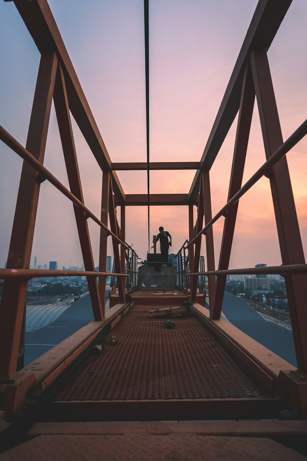 man in black jacket standing on brown wooden dock during daytime