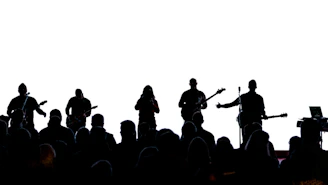 silhouette of people standing on top of mountain