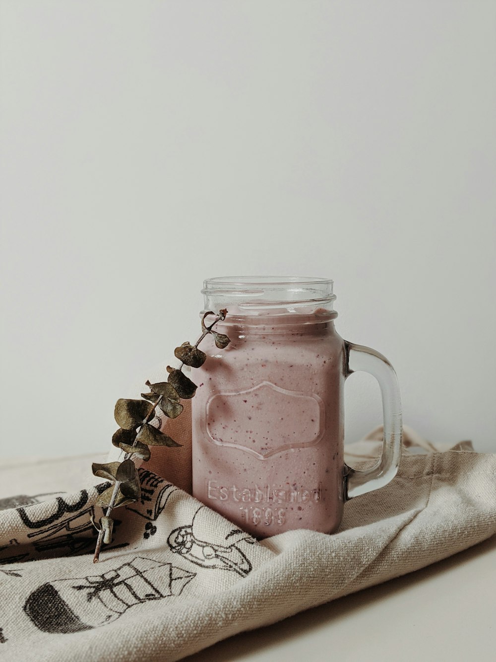 clear glass jar with pink liquid inside