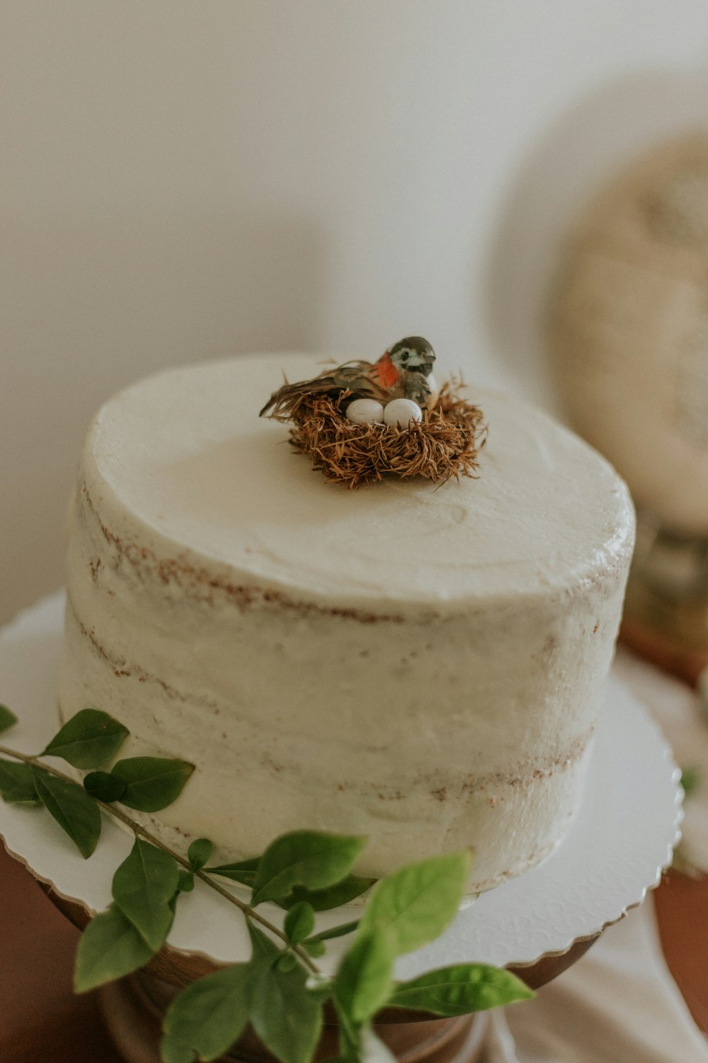white round cake with green leaves on top