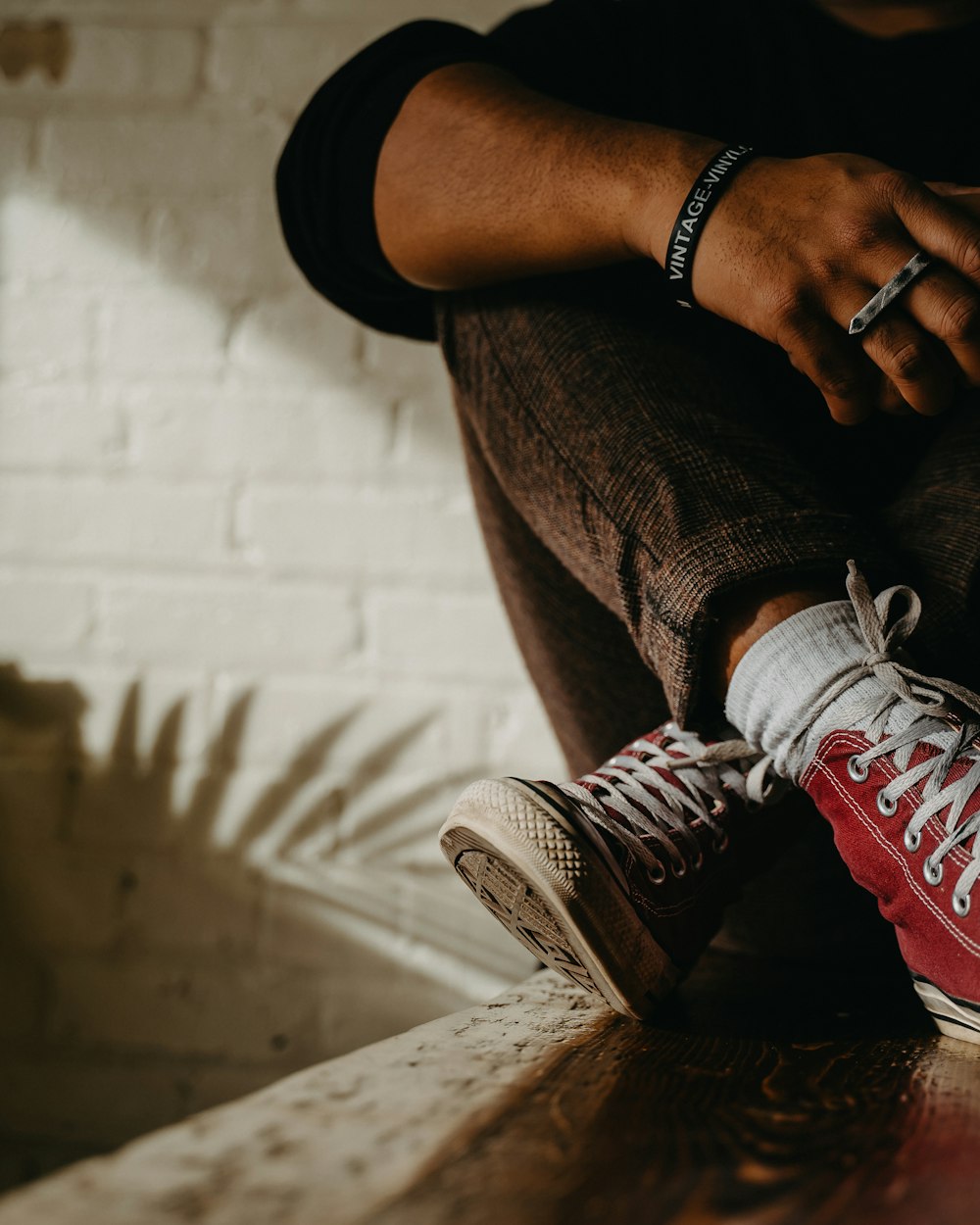 person in gray pants wearing black and white nike sneakers