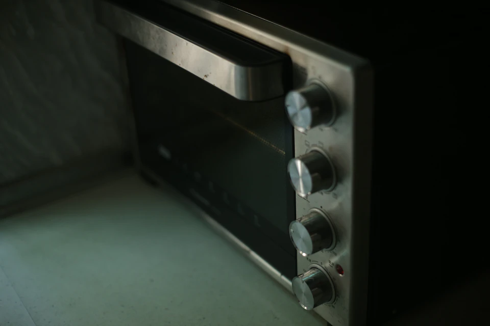 Close-up of stainless-steel range control knobs