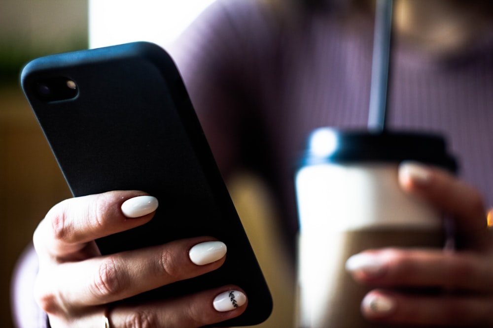 person holding black iphone 7