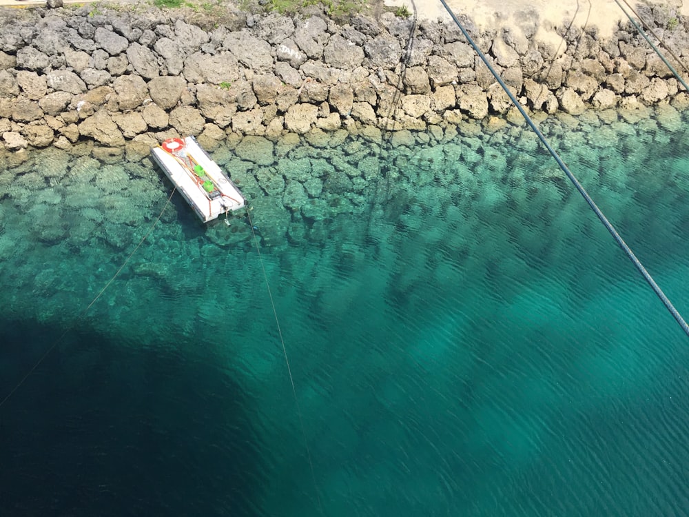 white and red boat on water during daytime