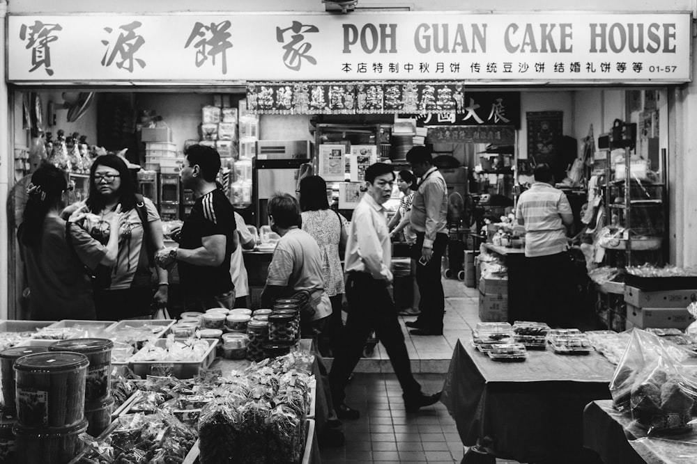 grayscale photo of people in store