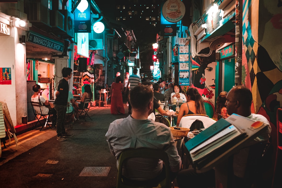 people sitting on chair near street during night time