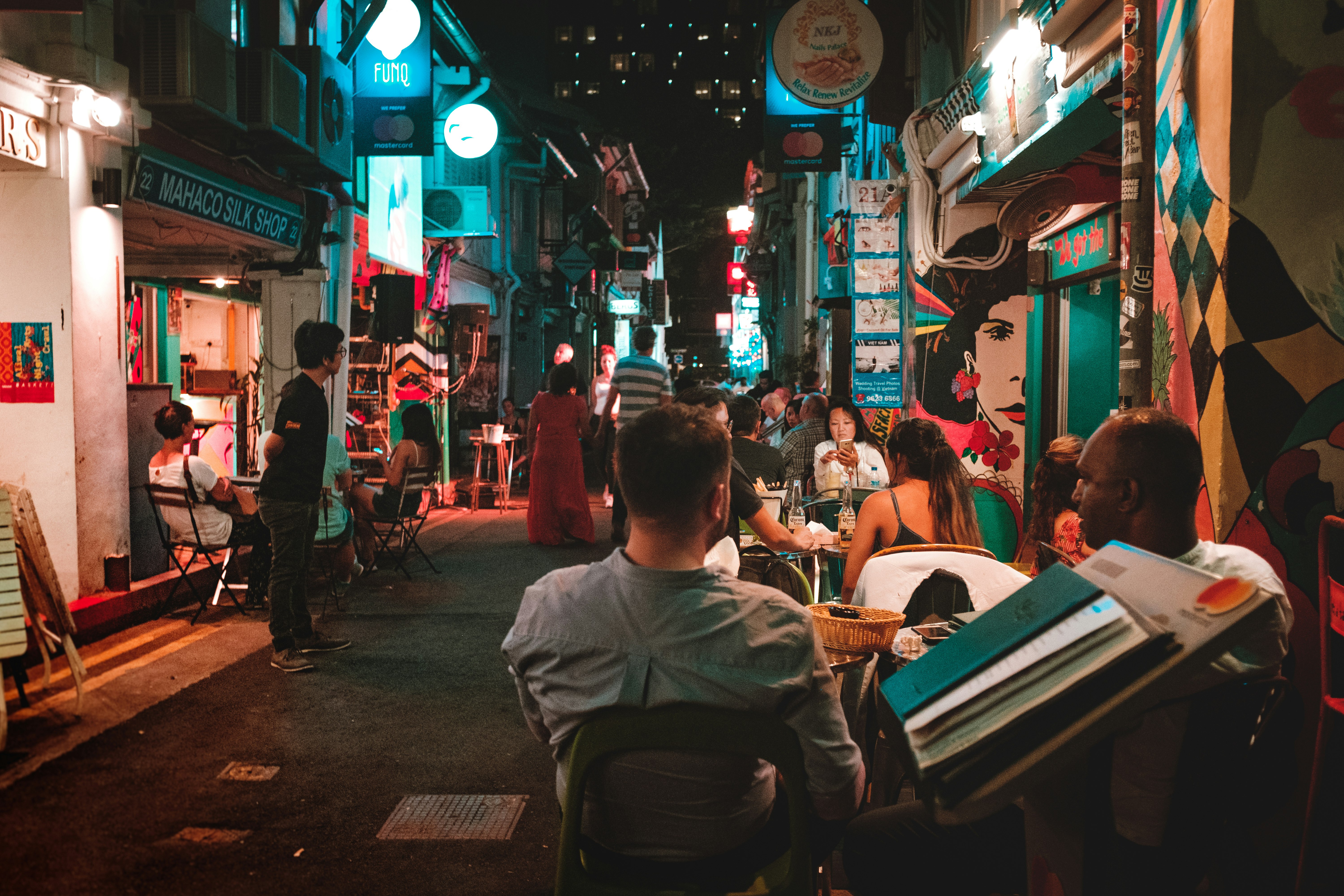 people sitting on chair near street during night time