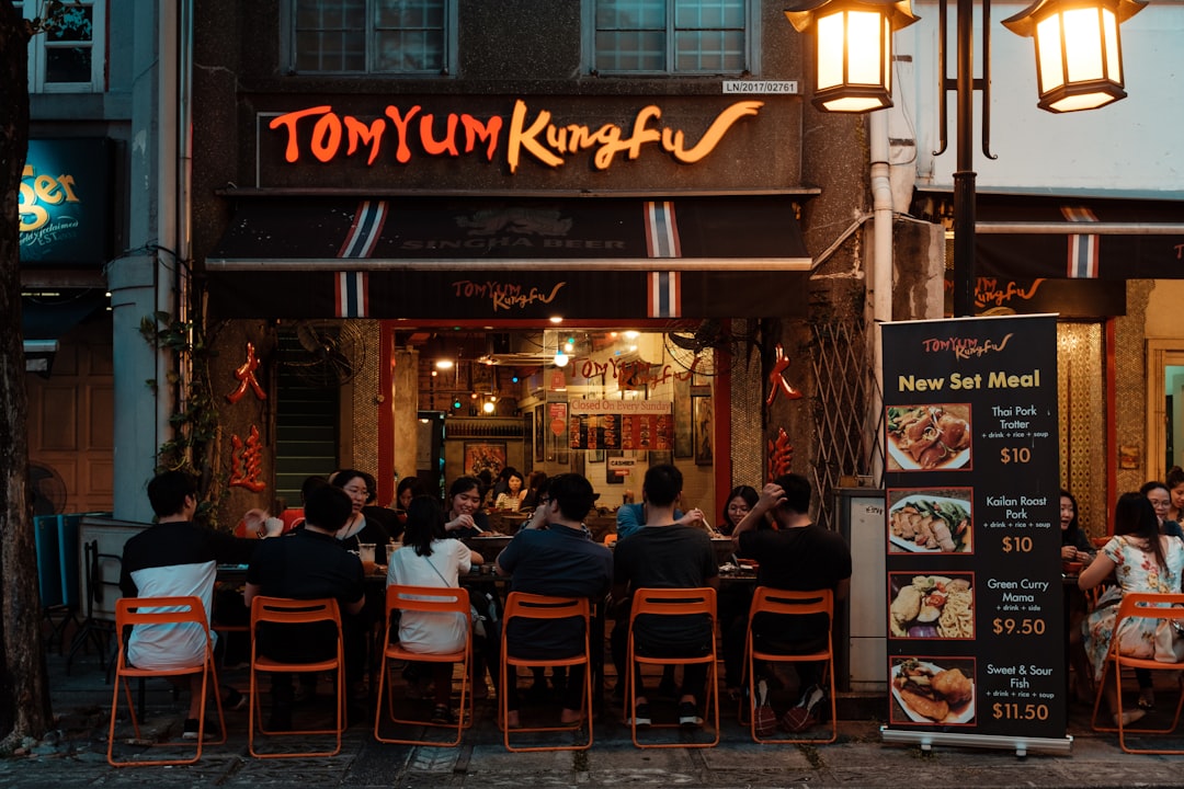 people sitting on chair in restaurant, Eating Thai food at a Restaurant