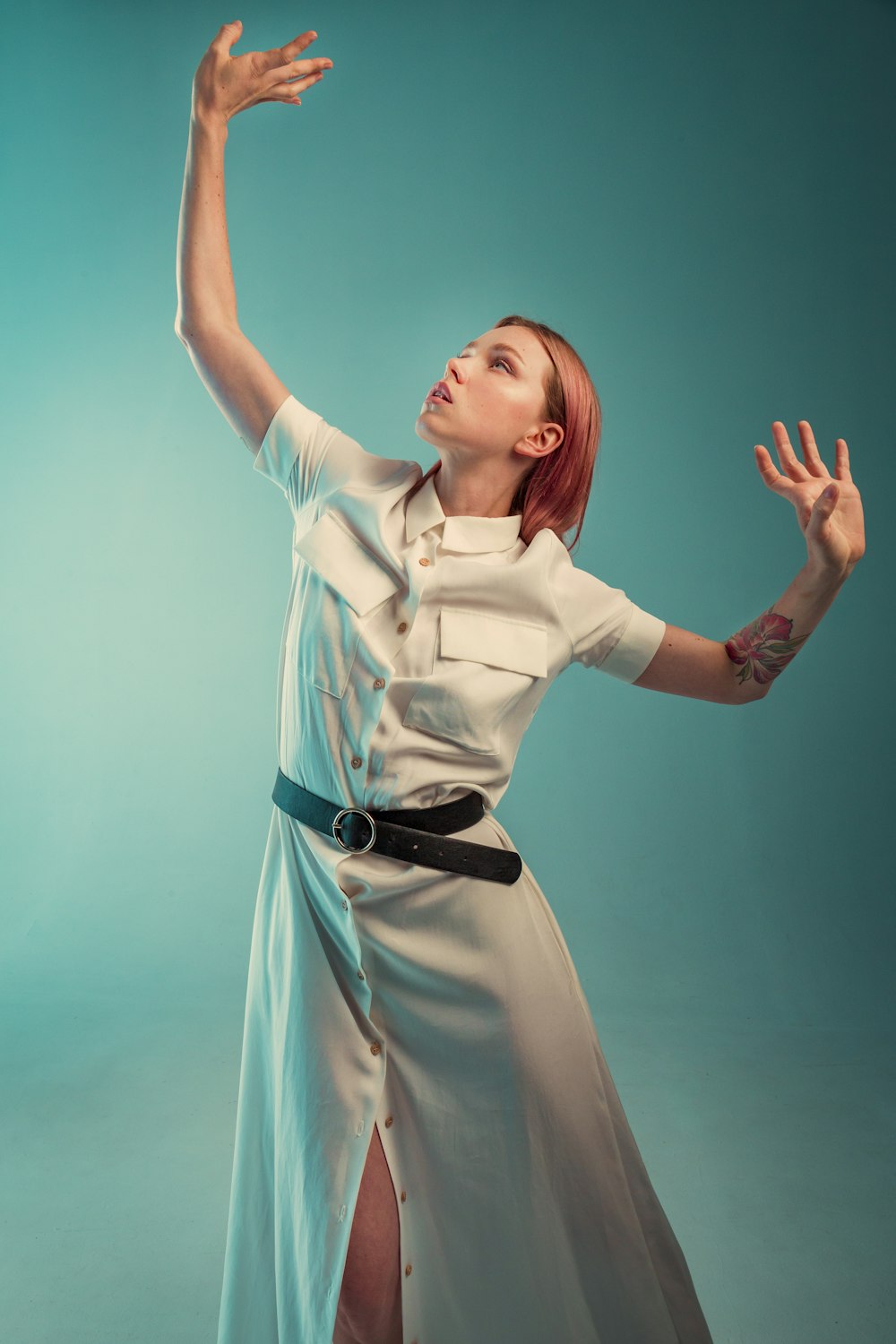 woman in white dress shirt with black leather belt