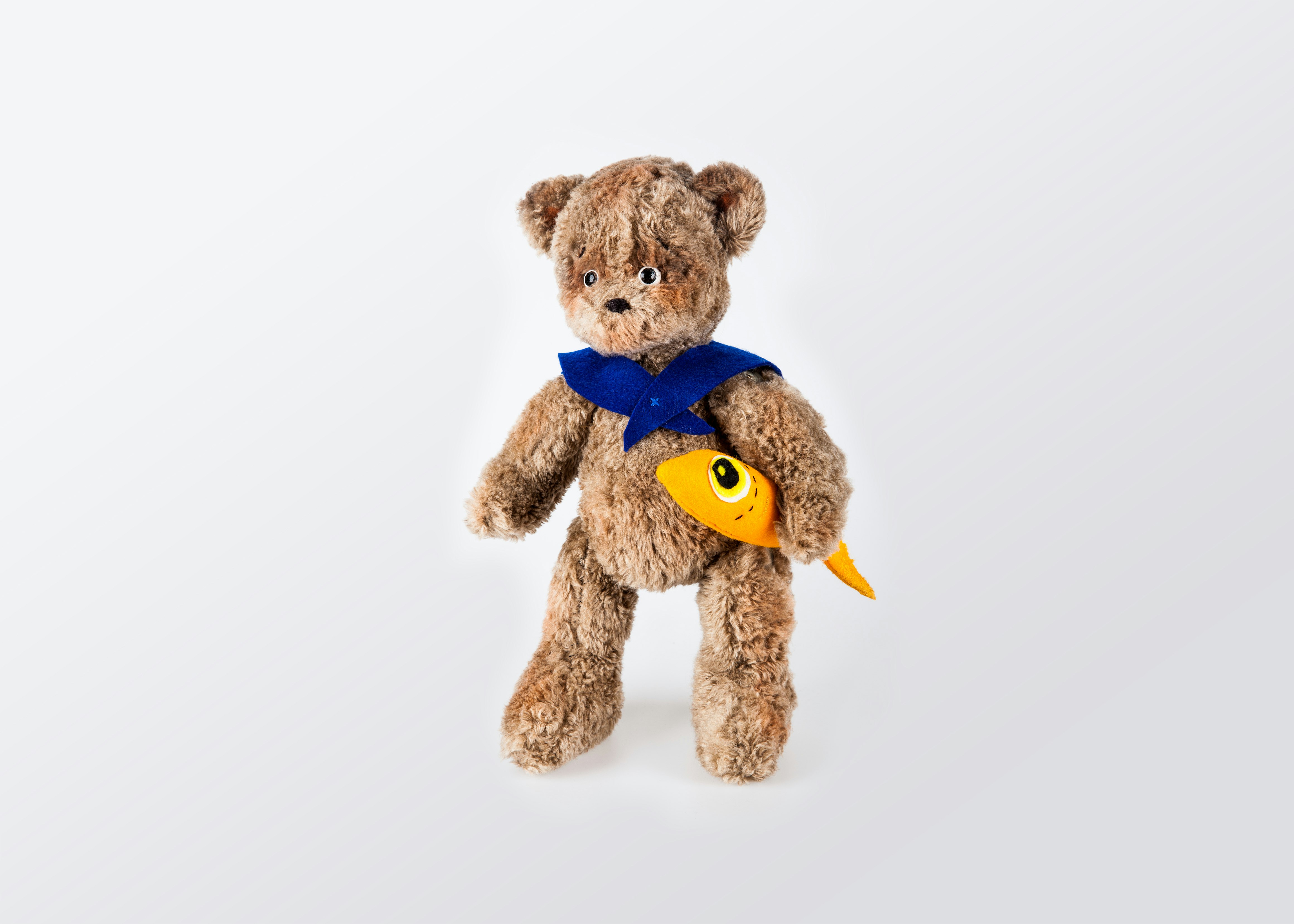 brown bear plush toy on white surface