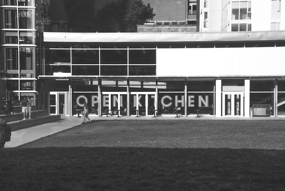 grayscale photo of building near trees