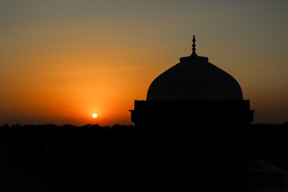 silhouette of dome building during sunset