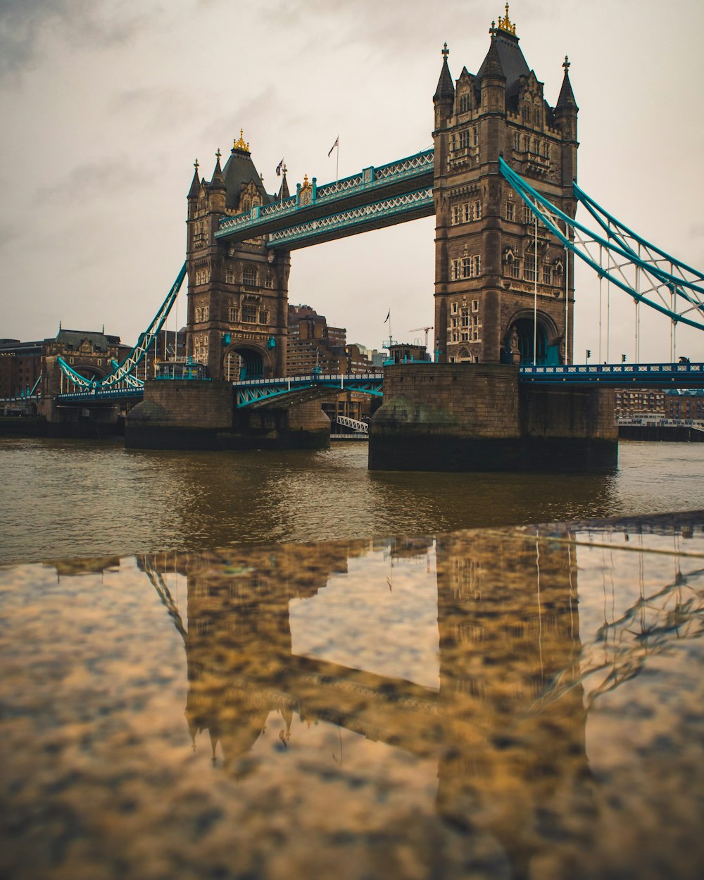 brown and gray bridge under blue sky during daytime