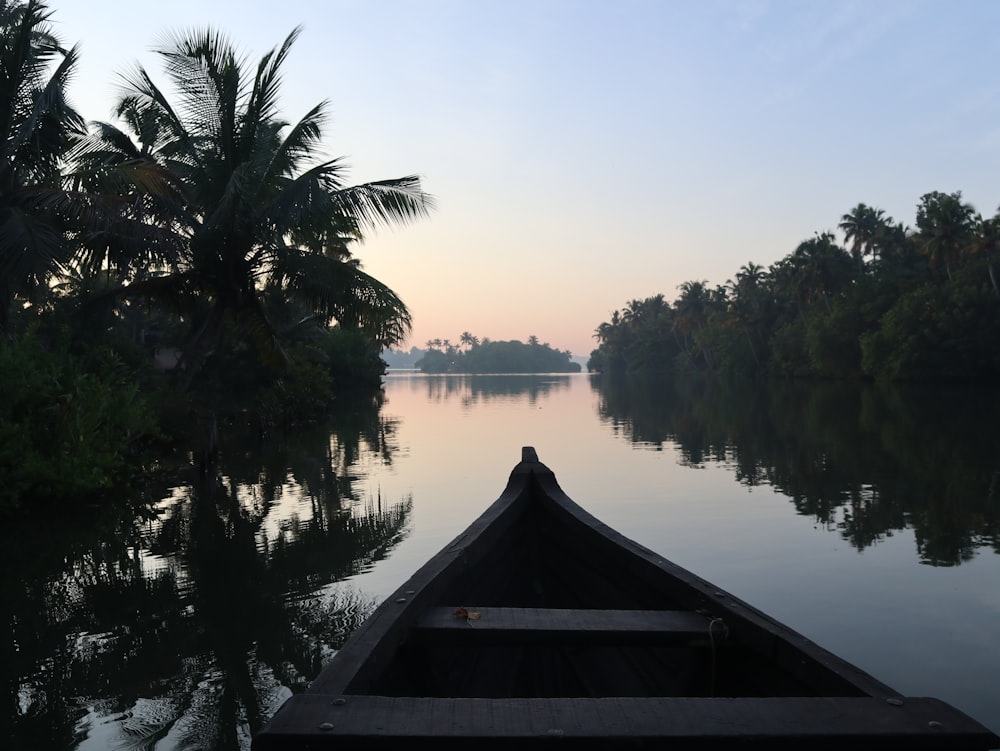 brown wooden boat on lake during daytime