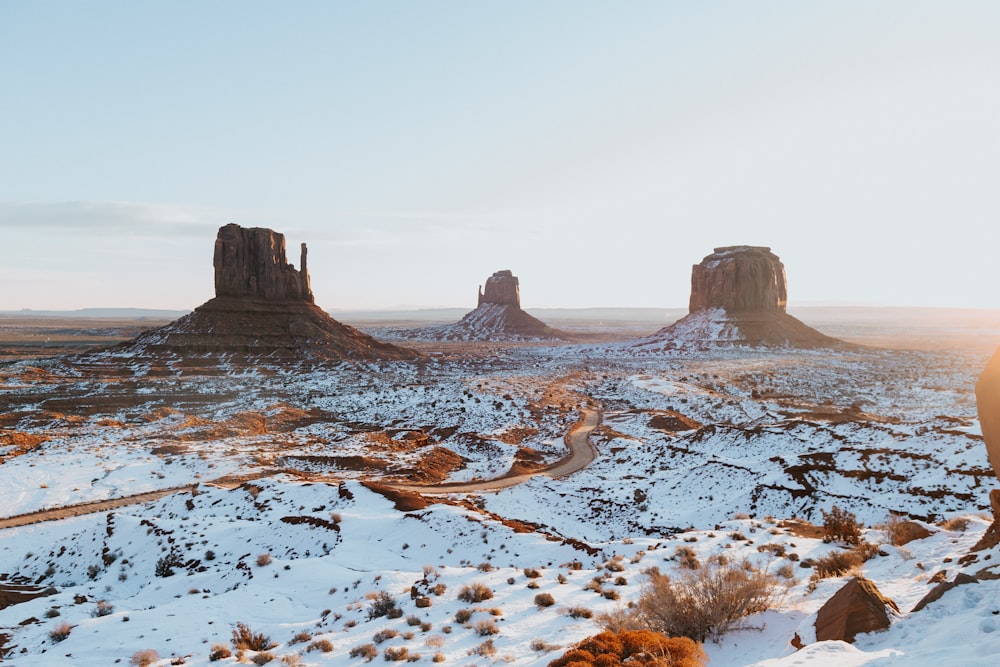 brown rock formation on white snow covered ground during daytime