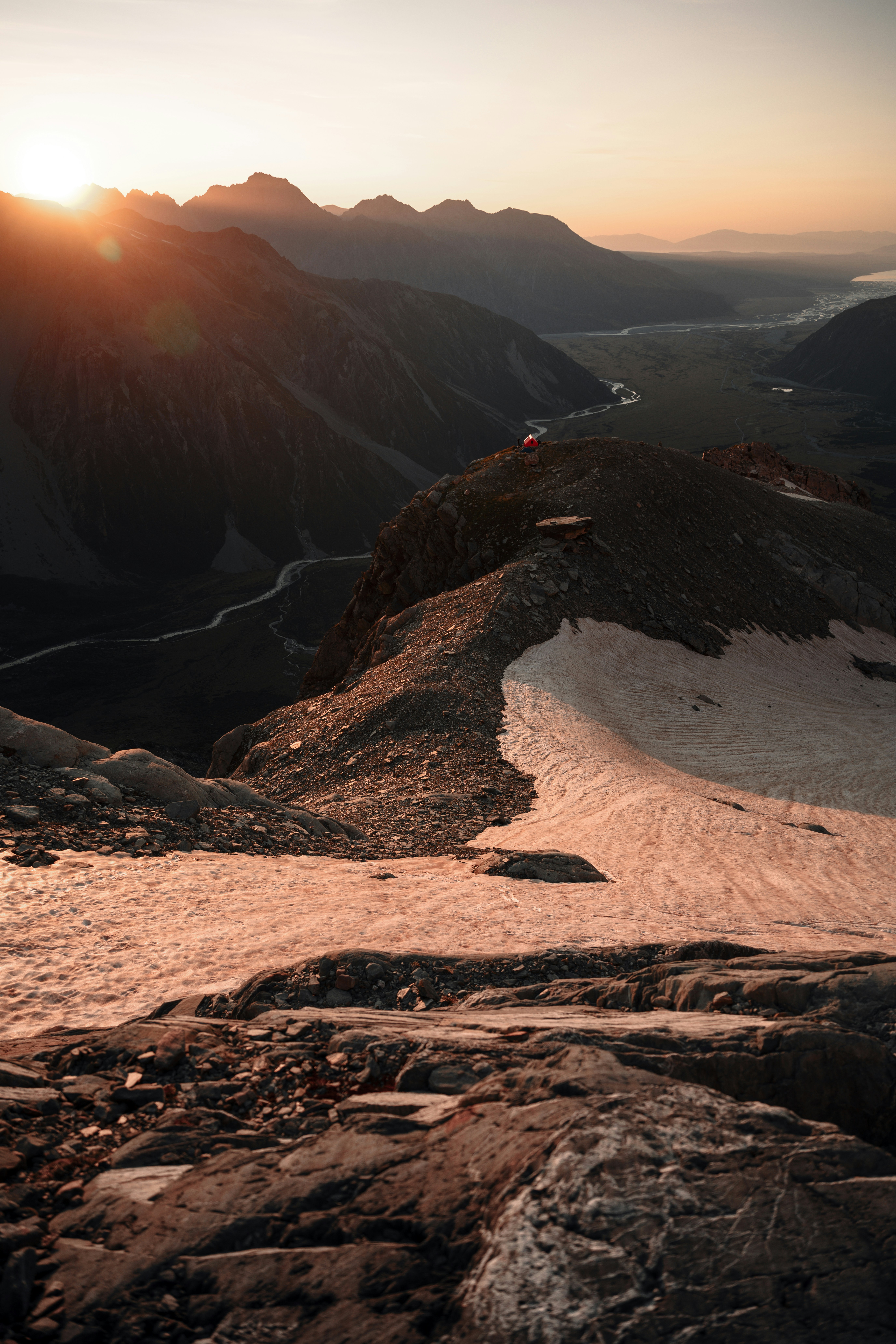 brown rocky mountain near body of water during daytime