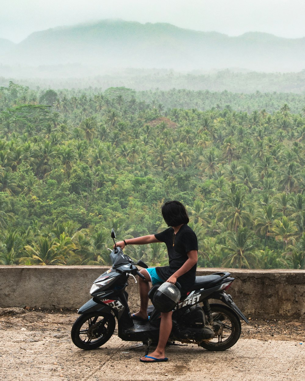 man in black shirt riding motorcycle during daytime