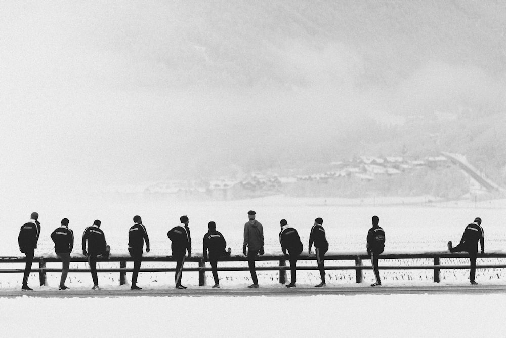 group of people standing on snow covered ground