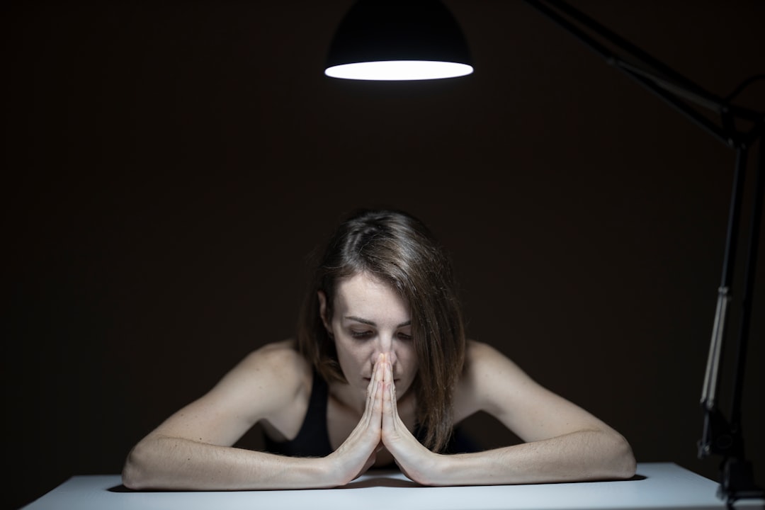 topless woman sitting on chair, portrait of a sad woman