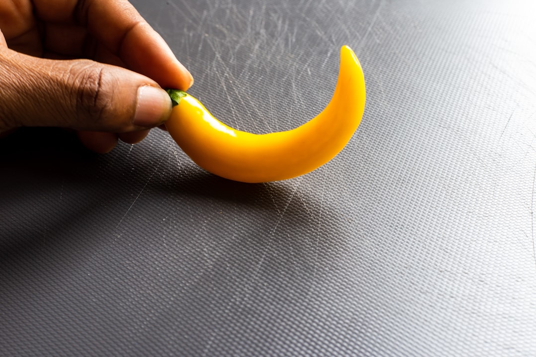 yellow banana on gray textile
