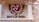 A decorative wall features a circular emblem with a stylized Om symbol in white on a red background accompanied by the text 'Ministry of Culture Govt. of India'. To the right, there is a detailed sculpture of a traditional Indian figure carved into the sandstone.