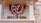 A decorative wall features a circular emblem with a stylized Om symbol in white on a red background accompanied by the text 'Ministry of Culture Govt. of India'. To the right, there is a detailed sculpture of a traditional Indian figure carved into the sandstone.