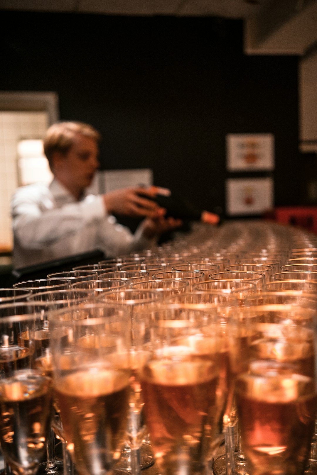 man in white dress shirt holding clear glass cup