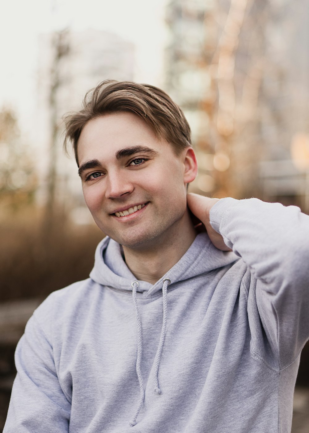 man in gray hoodie smiling