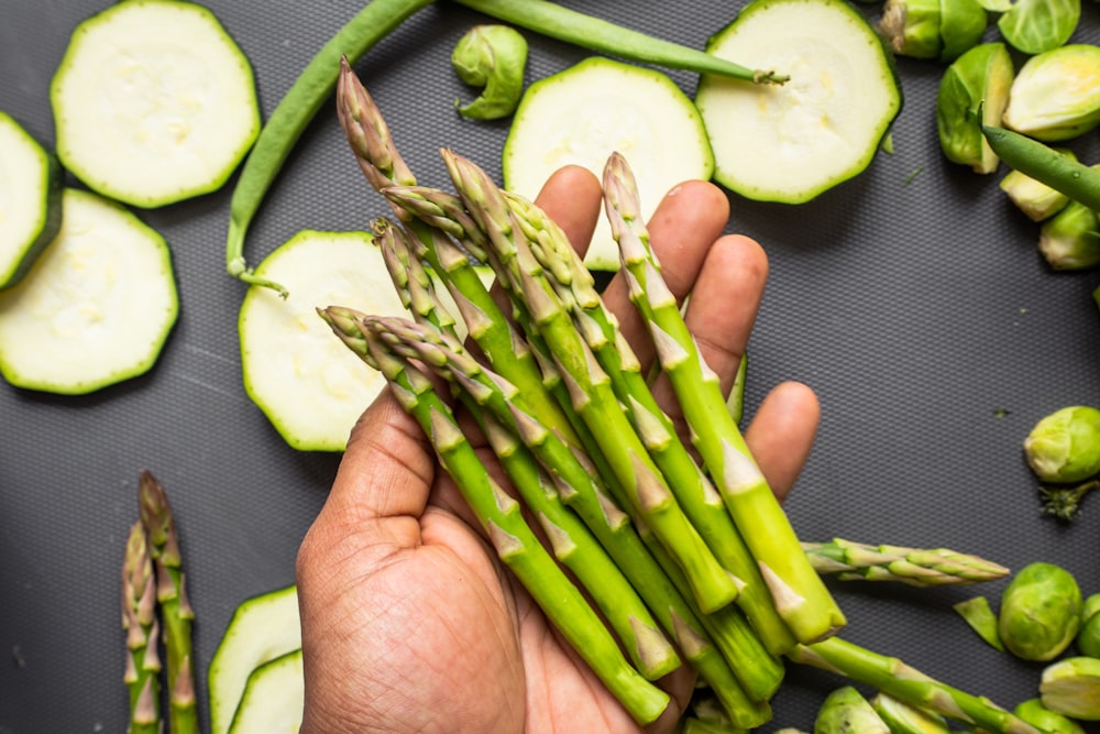 sliced cucumber on persons hand