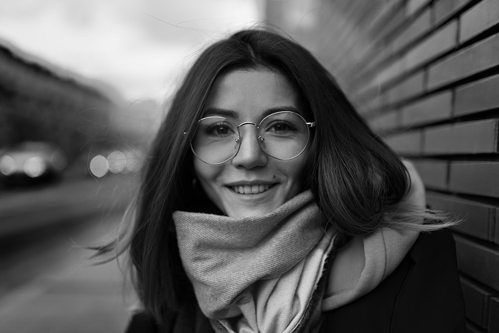 grayscale photo of woman wearing eyeglasses and scarf