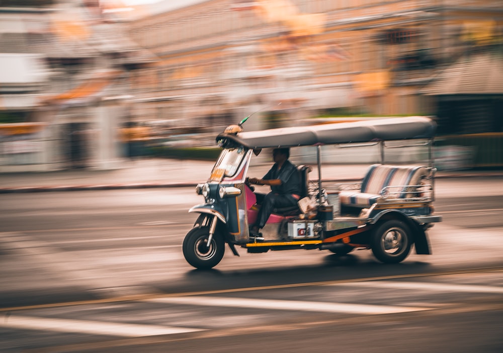 man driving yellow and black golf cart