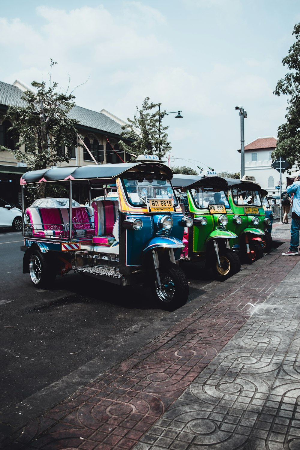 blue and green auto rickshaw on road during daytime